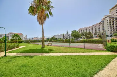 a park with a palm tree and a sidewalk at SouthView Studio Silchoro AL in Albufeira