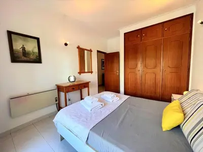 a bedroom with a bed with two towels on it at Albufeira Classic 1 With Pool by Homing in Albufeira