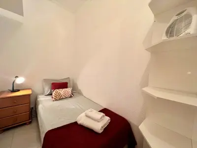 a small room with a bed with towels on it at Albufeira Classic 1 With Pool by Homing in Albufeira