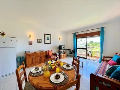 a kitchen and dining room with a table and a refrigerator at Albufeira Classic 1 With Pool by Homing in Albufeira