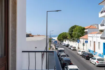 a balcony with a view of a street with cars at Ténis Mar F in Albufeira