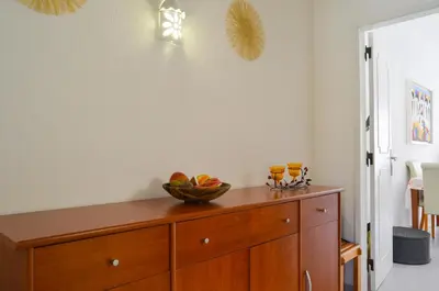 a wooden cabinet with a bowl of fruit on it at BeGuest Feliz Choro Apartment in Branqueira