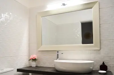 a white bathroom with a sink and a mirror at BeGuest Feliz Choro Apartment in Branqueira