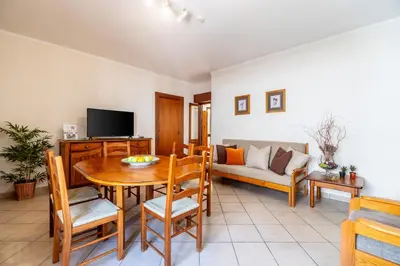a living room with a table and a couch at Ténis Mar E in Albufeira