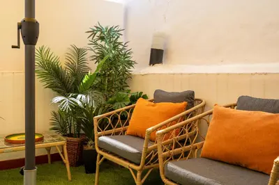 a group of chairs and a table with plants at Ténis Mar E in Albufeira