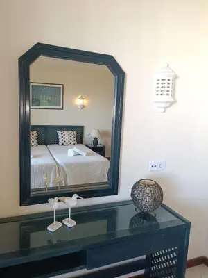 a bedroom with two beds and a desk and a mirror at Apartamento Bela Vista Tennis Club, FREE WIFI - By Algarkasa in Albufeira