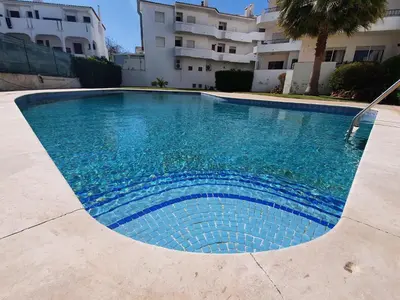a swimming pool in front of a building at BeGuest Areias Apartment in Albufeira