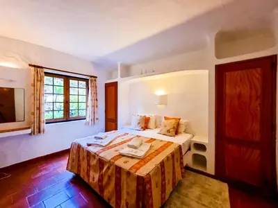 a bedroom with a bed and a window at FLH Balaia House with Terrace in Albufeira
