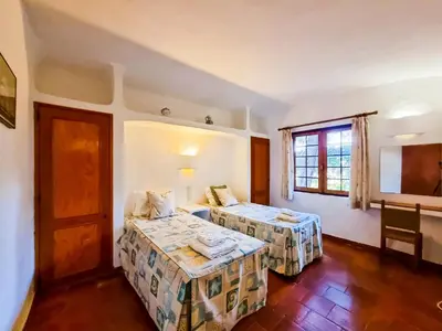a hotel room with two beds and a window at FLH Balaia House with Terrace in Albufeira