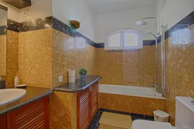 a bathroom with a sink and a shower and a toilet at Apartamento Olhos D'Água VistaBella in Olhos de Água