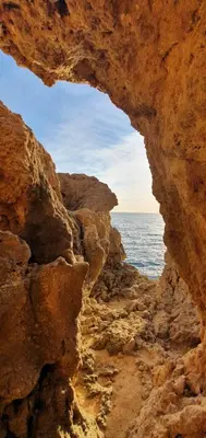 a view of the ocean through a rock cave at New Appartment! Albufeira in Albufeira