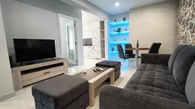 a living room with a couch and a tv at New Appartment! Albufeira in Albufeira