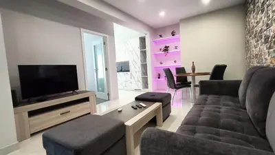 a living room with a couch and a tv at New Appartment! Albufeira in Albufeira