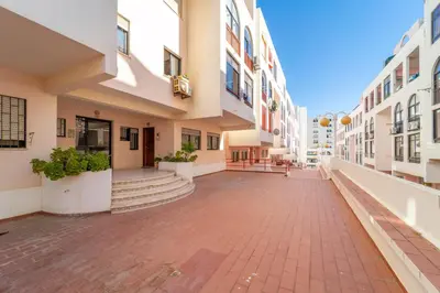 an empty street in a city with buildings at Quarteira Beach - 2 D by HelloVacations in Loulé