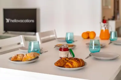 a table with plates of croissants and other pastries at Quarteira Beach - 2 D by HelloVacations in Loulé