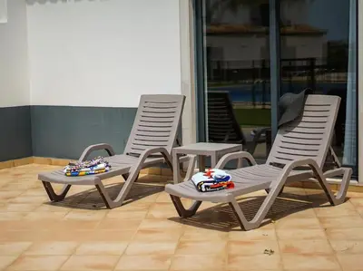 two chairs sitting on a patio with toys on them at Magnólia O House by Stay ici Algarve Holiday Rental in Albufeira