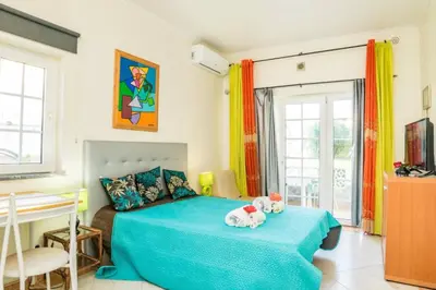 a bedroom with a bed with two stuffed animals on it at Apartamento Studio Anastacio in Albufeira