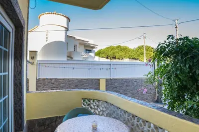 a car parked in front of a house with a fence at Apartamento Studio Anastacio in Albufeira