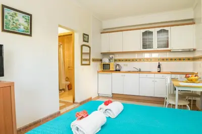 a balcony with a table and a lighthouse at Apartamento Studio Anastacio in Albufeira