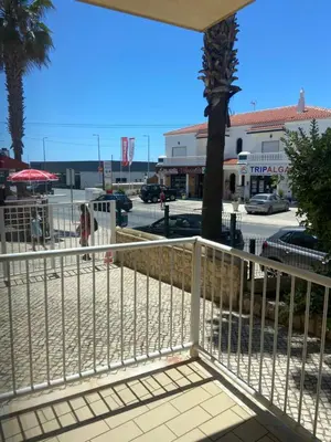 a white fence in front of a parking lot at Parra Home Holidays - Close to Galé Beach in Guia