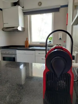 a kitchen with a red vacuum in the middle at Quinta do Lago Golf, Sea & Sun in Quinta do Lago
