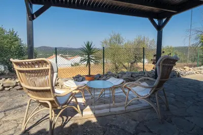a patio with a table and two chairs and a table at Cosy Farmhouse Quinta da Eira 140 years old in Loulé