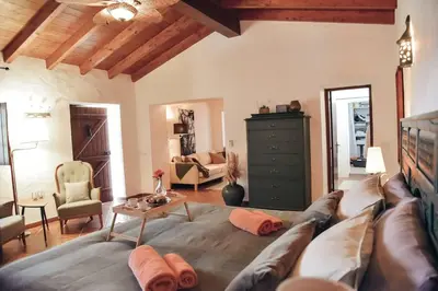 a living room with a couch and a table at Cosy Farmhouse Quinta da Eira 140 years old in Loulé