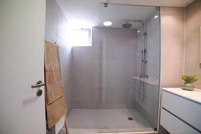 a bathroom with a shower with a glass door at One Bedroom Apartment Marina View in Albufeira