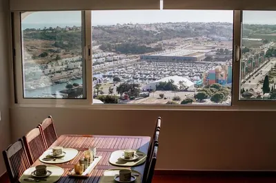 a table with a view of a city from a window at One Bedroom Apartment Marina View in Albufeira