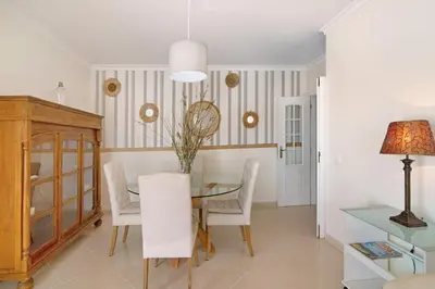 a dining room with a table and chairs at Pérola do Atlântico By the Sea in Quarteira