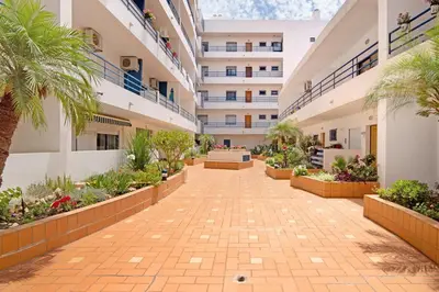 an internal courtyard of a apartment building with plants at Pérola do Atlântico By the Sea in Quarteira
