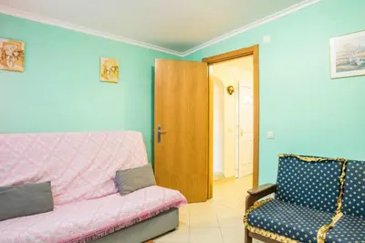 a living room with a couch and a chair at T1 Anastacio in Albufeira