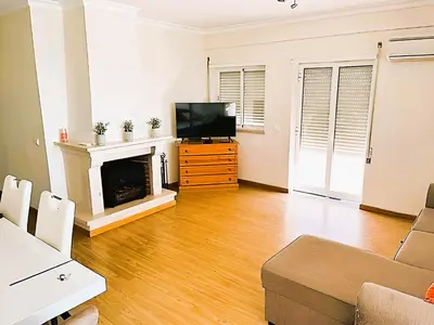 a living room with a television and a fireplace at Flat 3 Bedrooms Albufeira in Albufeira