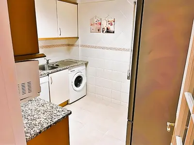 a small kitchen with a sink and a washing machine at Flat 3 Bedrooms Albufeira in Albufeira