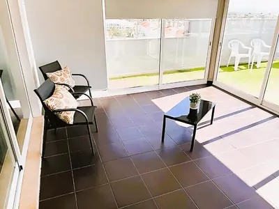 a room with two chairs and a table on a balcony at Flat 3 Bedrooms Albufeira in Albufeira
