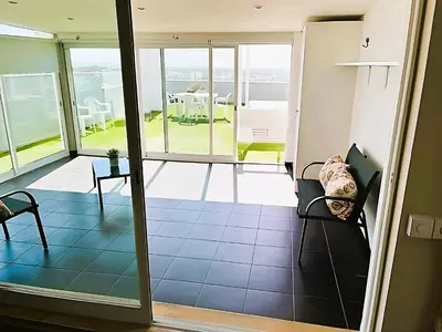 a view of a living room with a view of a patio at Flat 3 Bedrooms Albufeira in Albufeira