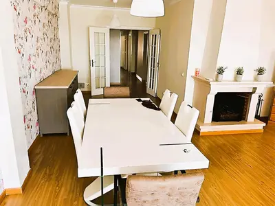 a white table and chairs in a room with a fireplace at Flat 3 Bedrooms Albufeira in Albufeira