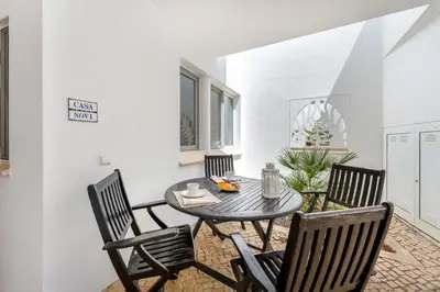 a dining room with a table and chairs at Casa Perola - Vale do Garrão in Almancil