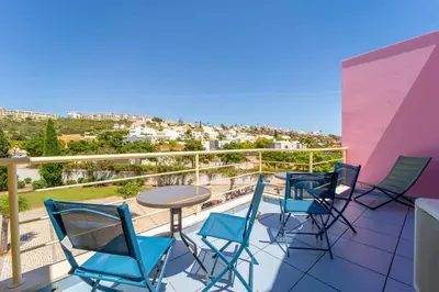 a balcony with chairs and a table with a view at Lovely LM Penthouse in Albufeira