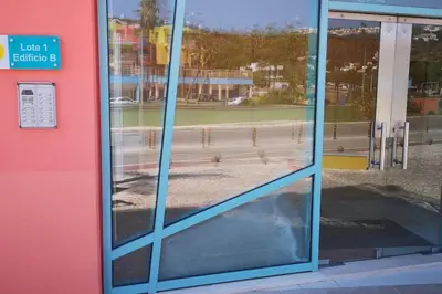 a reflection of a bench in the windows of a building at Joyful Marina - Albufeira in Albufeira