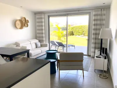 a living room with a couch and a table at Albufeira Malpique Beach Apartment in Albufeira