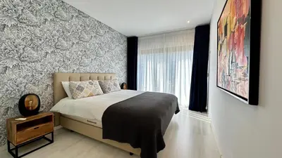 a bedroom with a large bed and a window at Cavalo Branco Portugal in Quarteira