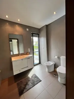 a bathroom with a sink and a toilet and a mirror at Cavalo Branco Portugal in Quarteira