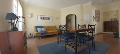 a living room with a table and a couch at Casa da Travessa - casa de férias no coração de Faro in Faro