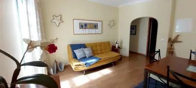 a living room with a couch and a table at Casa da Travessa - casa de férias no coração de Faro in Faro