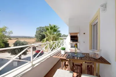 a balcony with a table and a view at Ae Flat Falesia in Albufeira