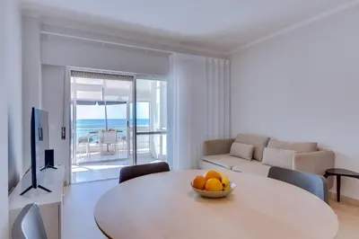 a living room with a table with a bowl of fruit on it at AL - Oceano T2 Frente Mar Quarteira in Quarteira