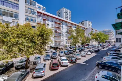 a parking lot full of cars in a city at AL - Oceano T2 Frente Mar Quarteira in Quarteira