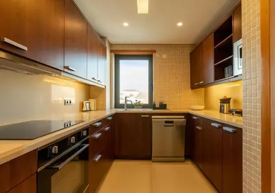 a large kitchen with wooden cabinets and a window at Algarve Vale Lobo Golf&Beach with Private Pool I in Vale do Lobo