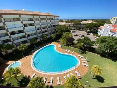 an overhead view of a swimming pool in front of a building at Vilamoura Avelãs Ocean View Apartment in Vilamoura